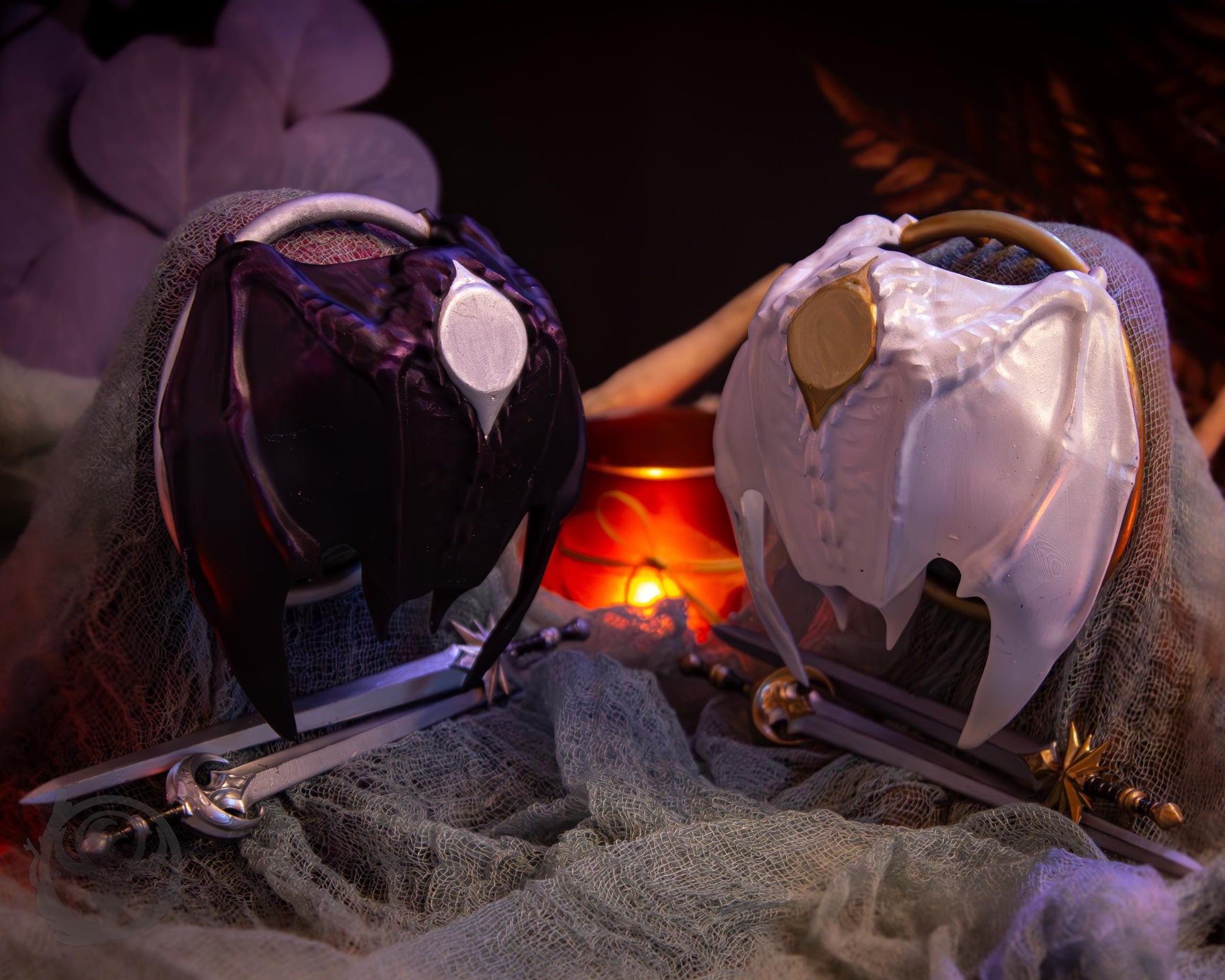 Two resin hair bun covers set up on stands, with their resin sword pins. The bun covers are dragon wings.
