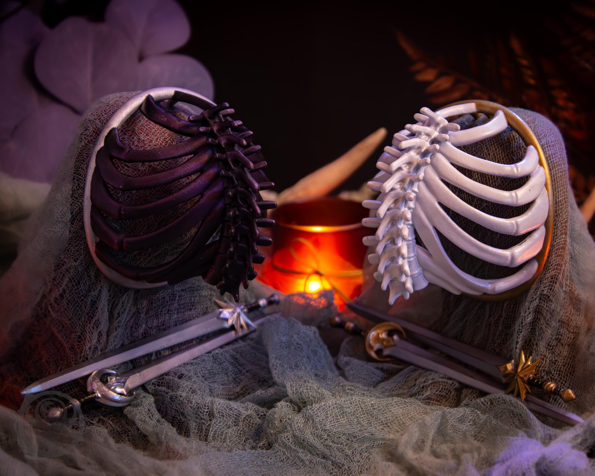Two resin hair bun covers set up on stands, with their resin sword pins. The bun covers are ribs with a spine in the center.