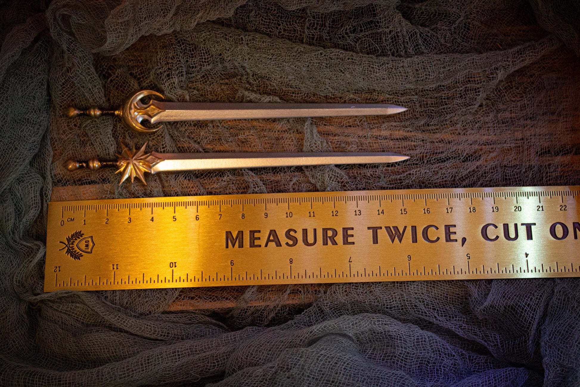 Measurement of sword pins (~15.5 cm) next to a ruler.